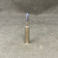 Metallic bullet casing on a gray textured background