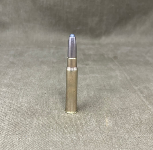 Metallic bullet casing on a gray textured background