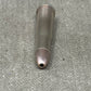 Metallic bullet casing on a gray concrete surface