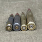 Four shotgun shells on a concrete surface