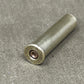 Metallic cartridge casing on a gray surface