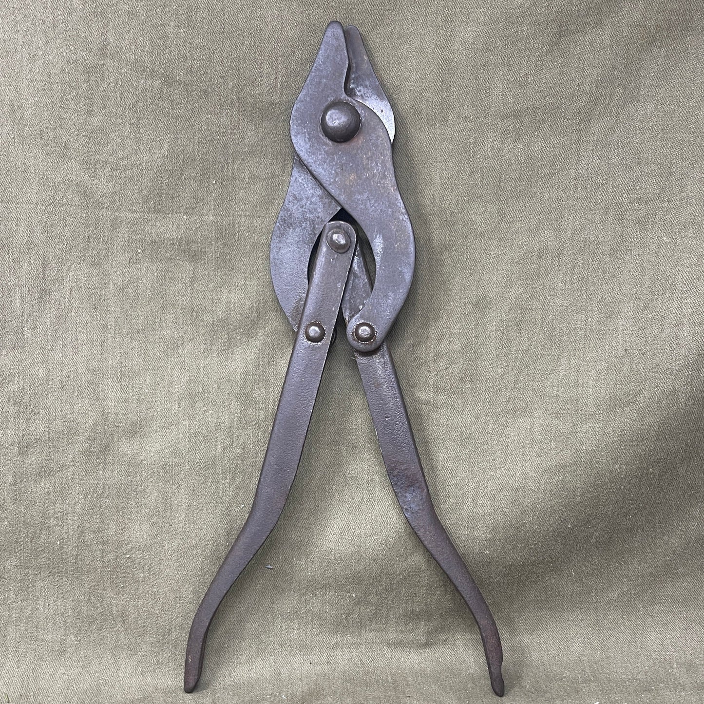 Original WWII British Wire Cutters, dated 1941 and manufactured by C.H.P., are durable steel tools designed for cutting barbed wire and battlefield obstacles. Featuring a spring-loaded mechanism and ergonomic handles, they were essential for British soldiers. Valued by collectors, these cutters represent wartime ingenuity and quality