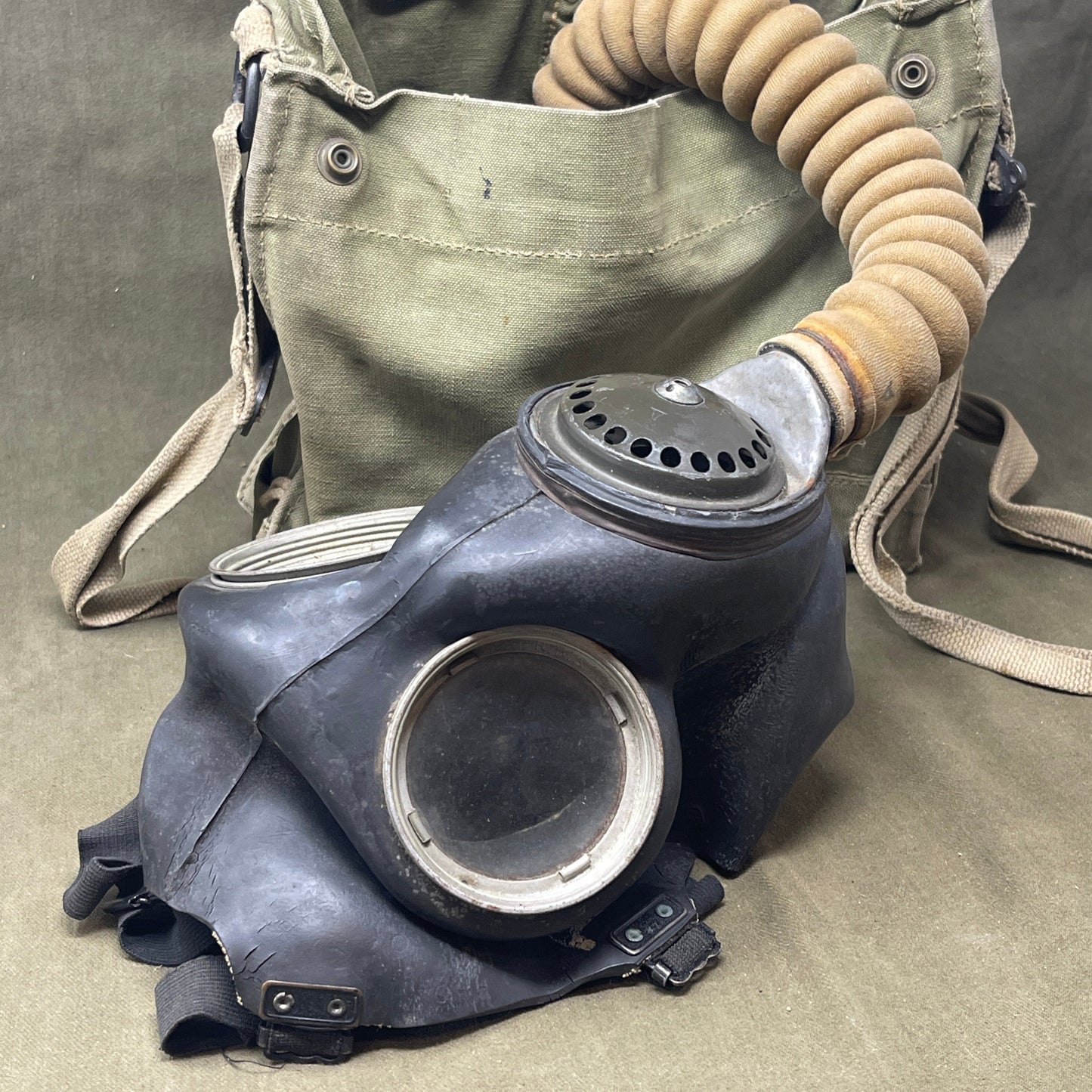 The British WW2 Respirator, Anti-Gas, General Service, Mk V, and Haversack, Mk VI provided essential protection against chemical warfare. The Mk V respirator featured a full-face rubber mask and filter canister, while the Mk VI canvas haversack ensured easy portability and access. Both were crucial for soldier safety during gas attacks