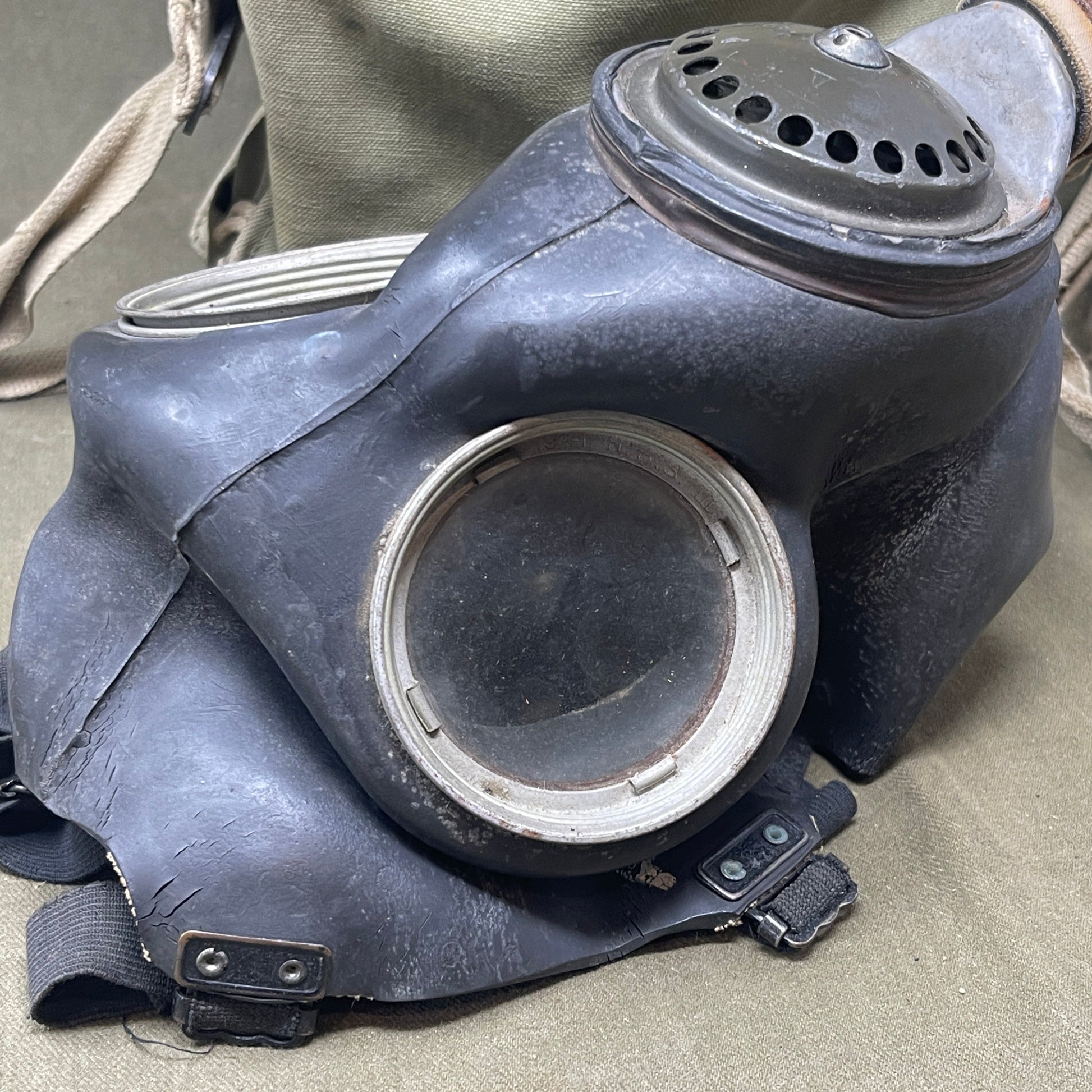 The British WW2 Respirator, Anti-Gas, General Service, Mk V, and Haversack, Mk VI provided essential protection against chemical warfare. The Mk V respirator featured a full-face rubber mask and filter canister, while the Mk VI canvas haversack ensured easy portability and access. Both were crucial for soldier safety during gas attacks