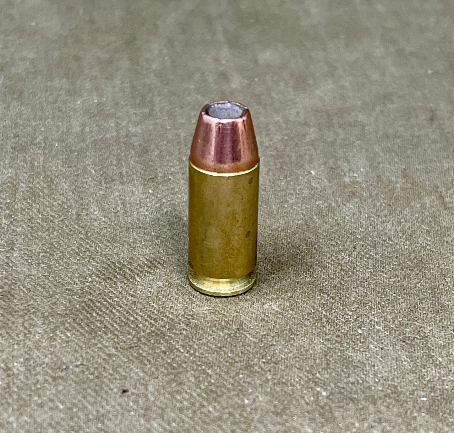 Bullet on a textured gray surface