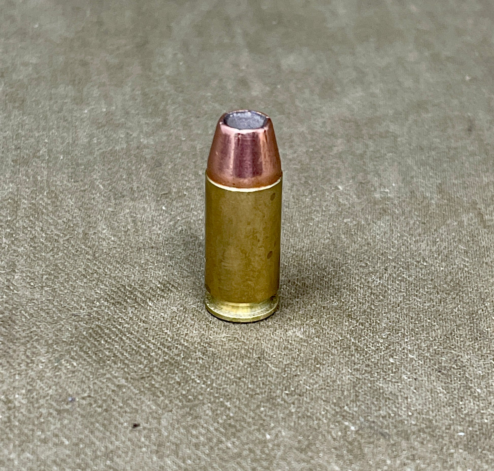 Bullet on a textured gray surface