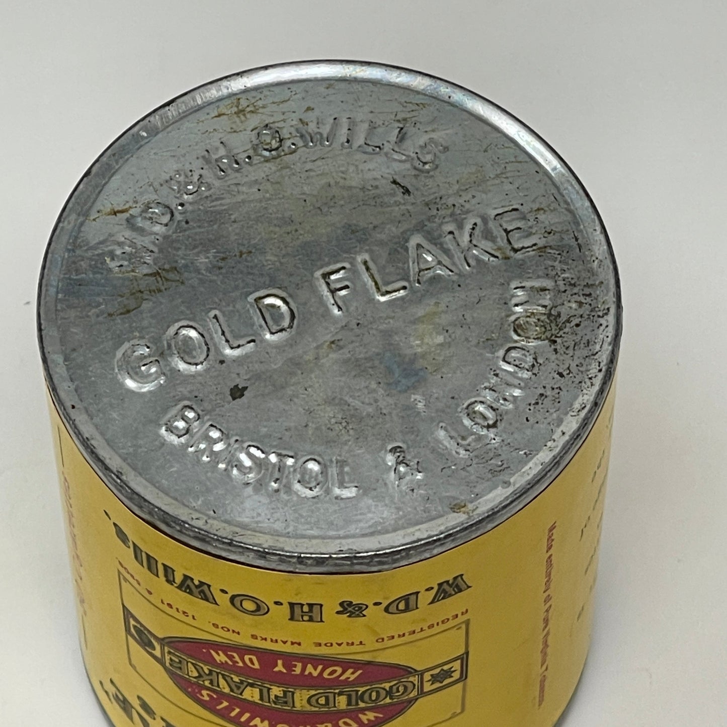 bottom view of an Airtight Sealed Can of 50 Gold Flake Cigarettes